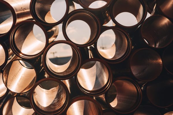 Plastic sewer pipes on construction site for system repairing stacked and ready to be installed